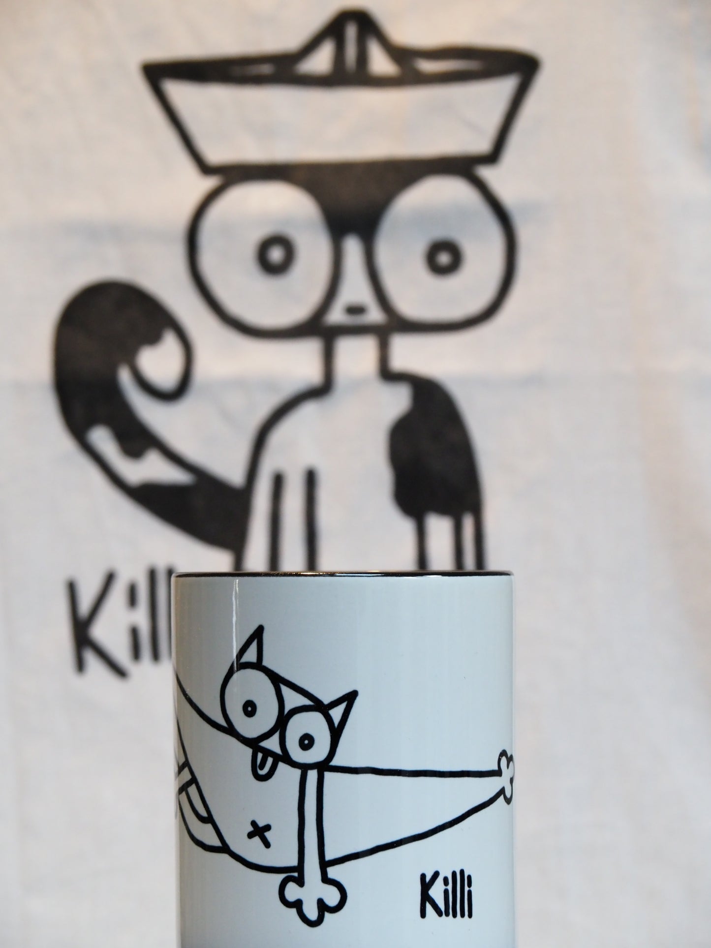 Mug with black and white cat self grooming with cartoon background