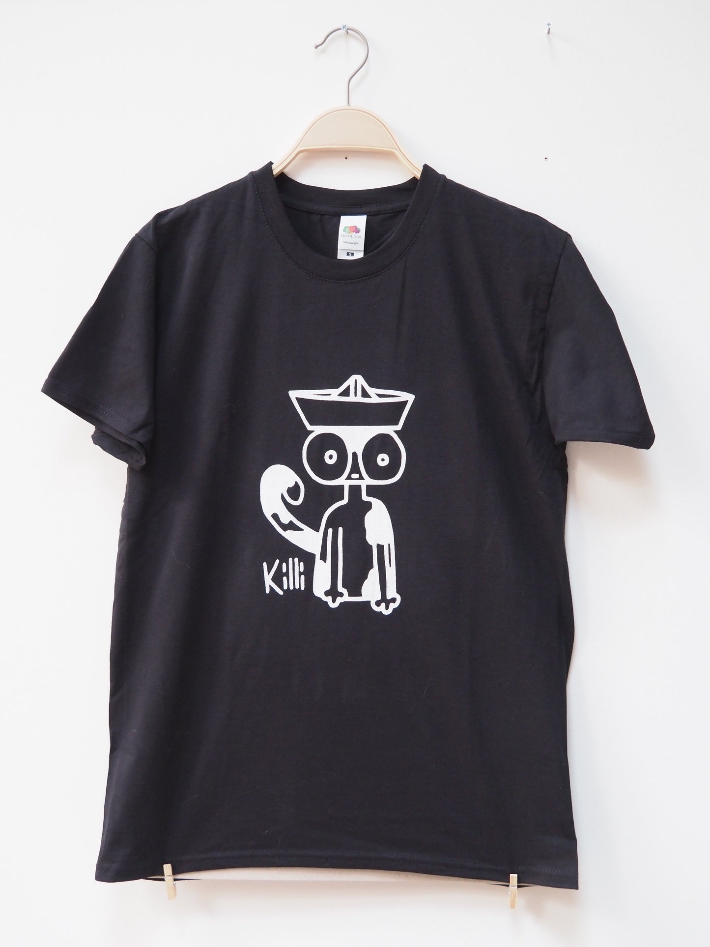 Black t-shirt with a white graphic design of a cat wearing a paper hat on a white background